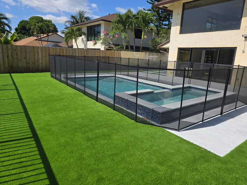 Newly built pool with marble coping and bubblers in Kendall