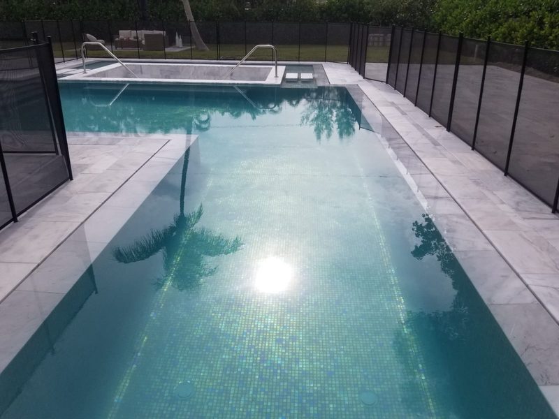 Geometric pool with iridescent glass interior in Fort Lauderdale